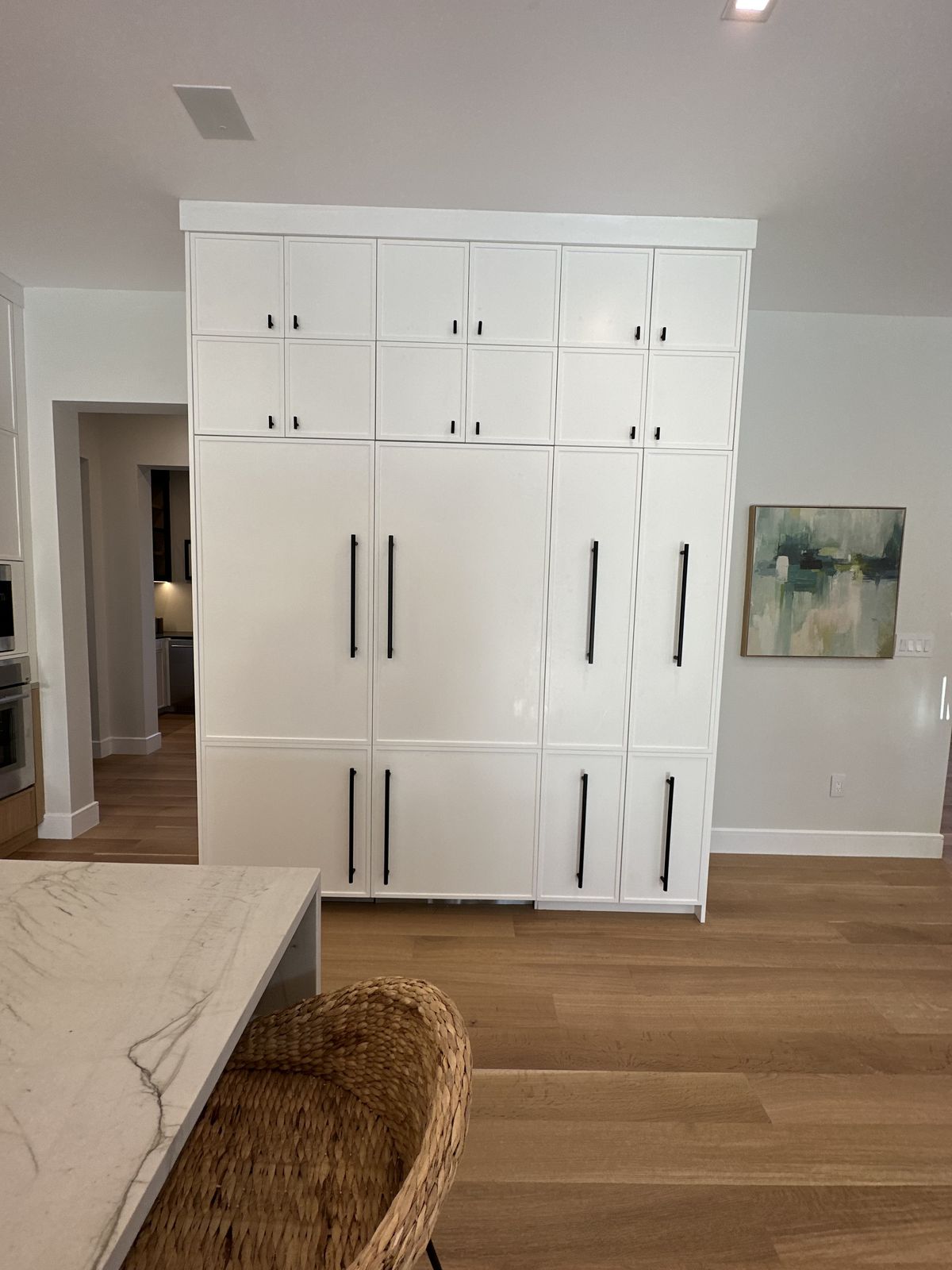 Custom oak closet system with adjustable shelving and soft-close drawers