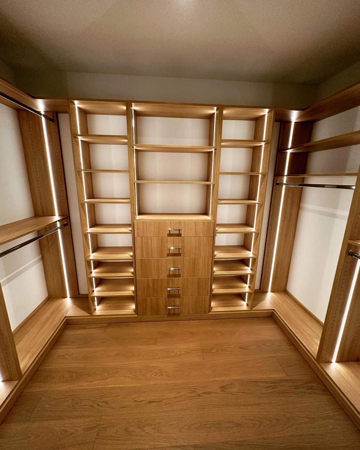 Master closet with full-height mirrors and custom oak organization system