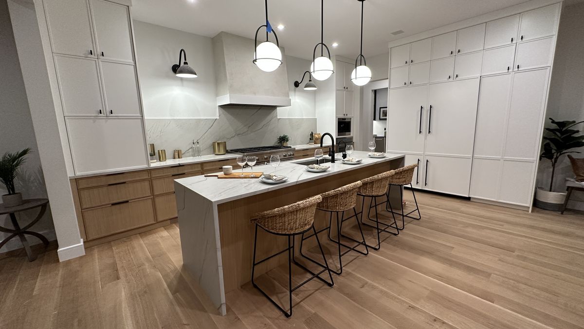 Kitchen with custom cabinetry, stone countertops, and subway tile