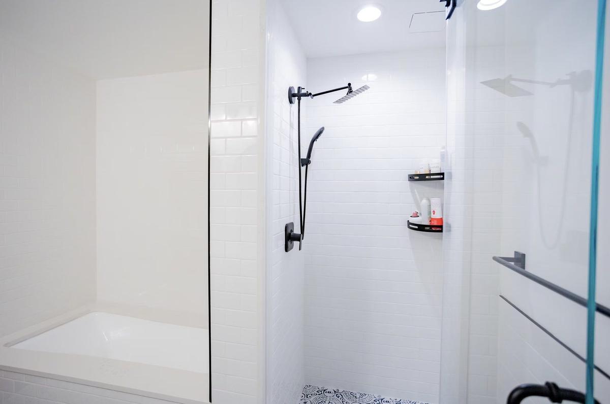 Walk-in shower with floor-to-ceiling tile and linear drain in NYC apartment bathroom