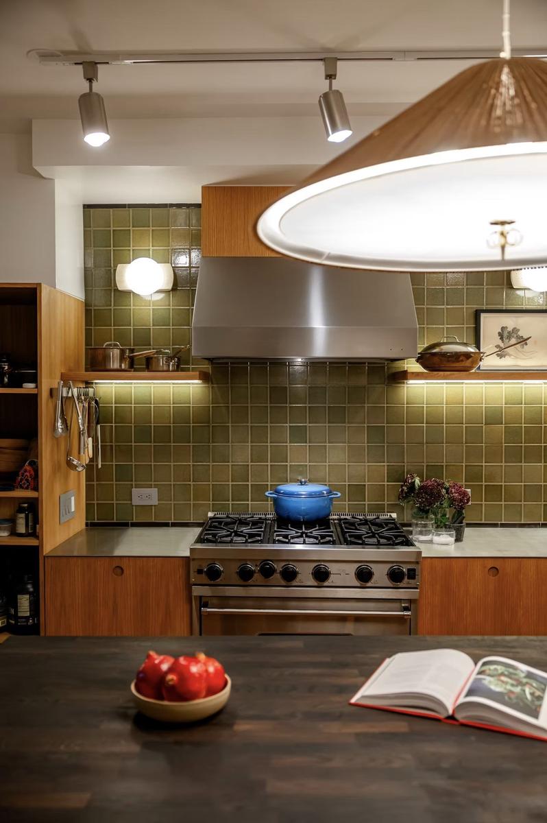 Kitchen detail showing custom cabinetry, integrated appliances, and stone countertops in Nolita