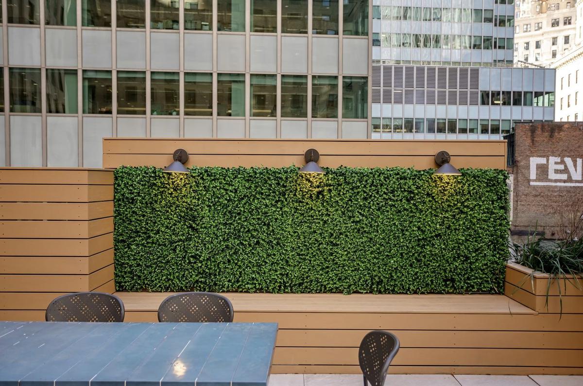 Green wall and outdoor dining space on NYC rooftop terrace renovation