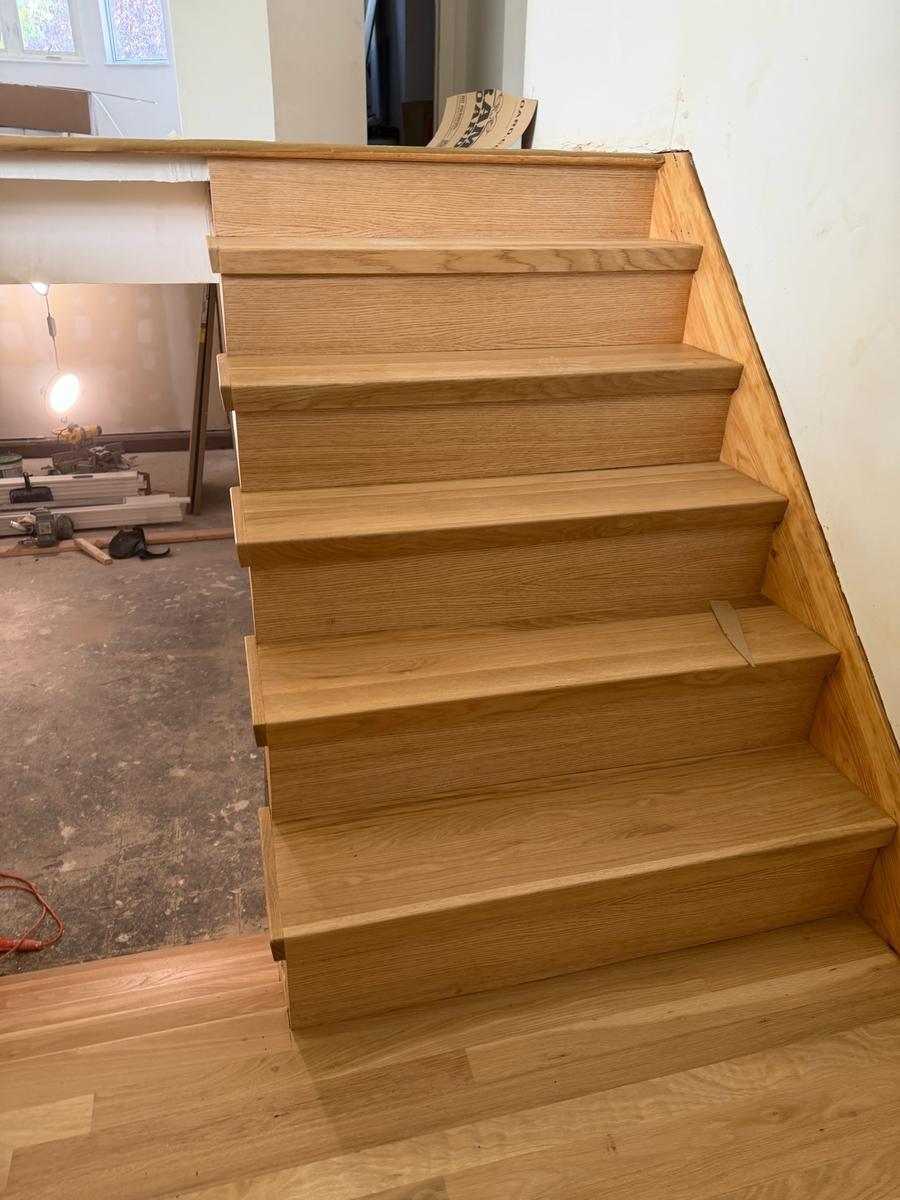 Custom oak stair treads and risers being installed