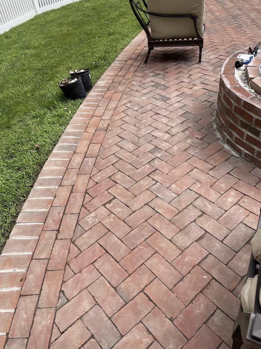 Herringbone brick patio installation at residential estate in Lattingtown Long Island