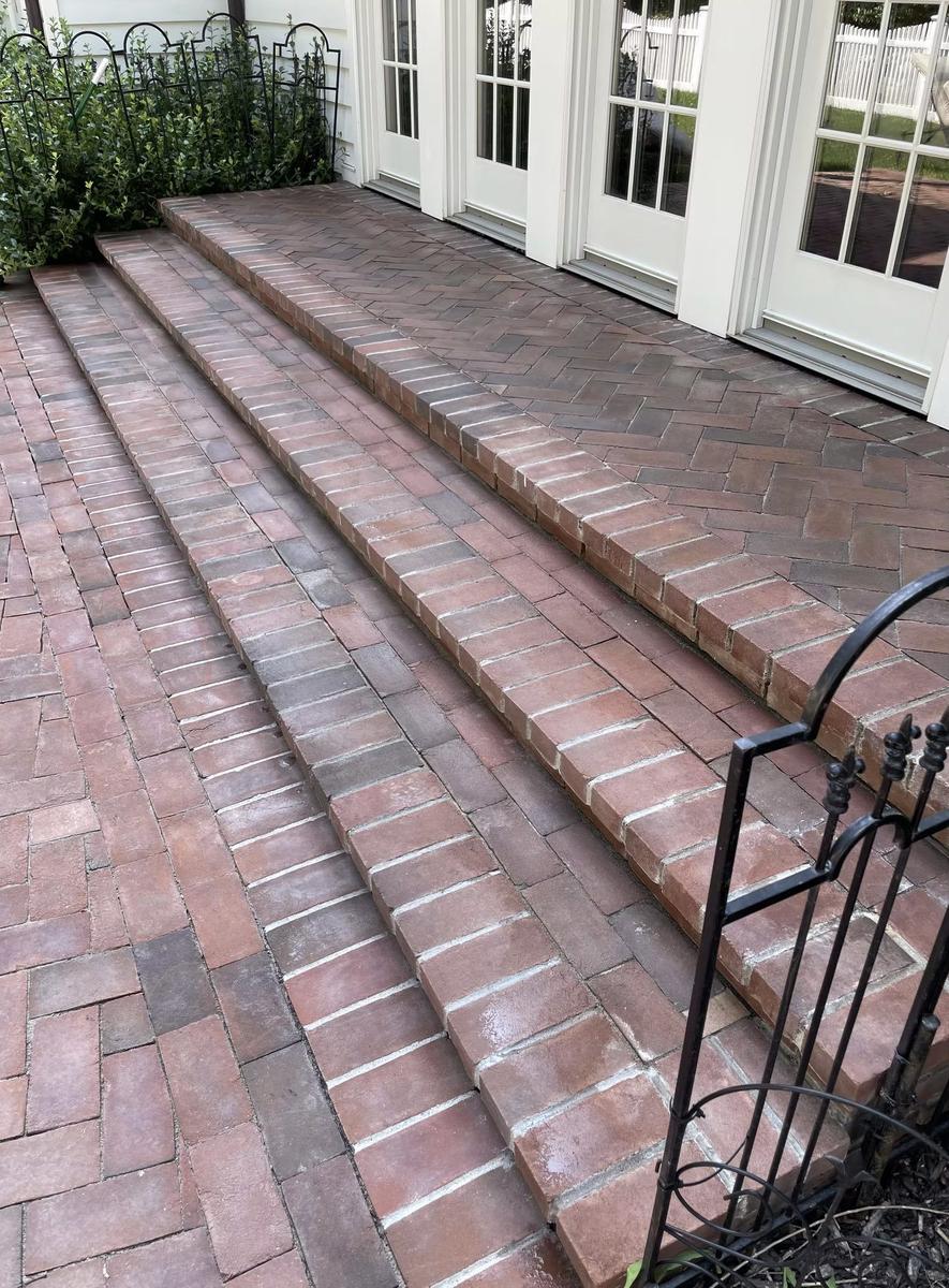 Custom brick entrance steps with stone borders at Long Island residential estate